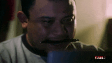a man holding a pen in his mouth with the word bull on the bottom