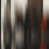 a blurred image of a person standing in a room