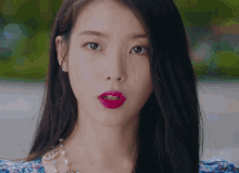 a close up of a woman 's face with red lipstick on