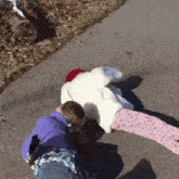 a person laying on the ground with a stuffed animal on their back
