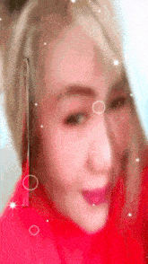 a close up of a woman 's face with a red background