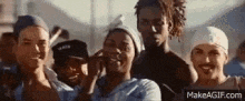 a group of people are standing next to each other and smiling for the camera .