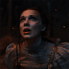 a close up of a woman 's face with blood coming out of her mouth