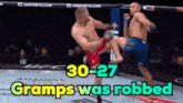 two men are fighting in a boxing ring with the words gramps was robbed