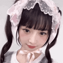 a girl with pigtails wears a pink headband