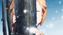 a girl peeking out from behind a tree trunk in the snow
