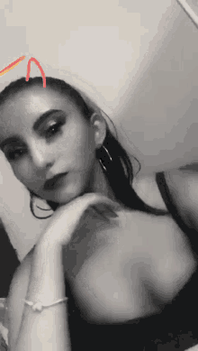 a black and white photo of a woman wearing a bracelet on her wrist