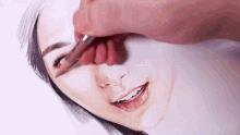 a close up of a person drawing a woman 's face with a pen that says " i love you " on it