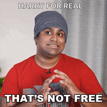 a man wearing a beanie and a red shirt says " that 's not free "