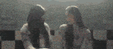two girls are standing in front of a sign that says linger ?