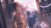 a couple of anime girls standing next to each other in front of a building