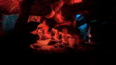 a bunch of stuffed animals in a dark room with a red light