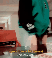 a person in a green shirt is standing upside down and says goes to look for tissues tissues-ah