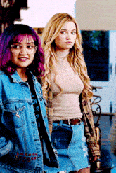 a girl with purple hair is wearing glasses
