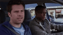 two men are sitting in a car with usa hd written on the bottom right
