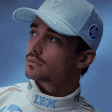 a man wearing a white shirt with ibm written on the collar