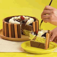 a person is cutting a cake with a yellow plate that says mr. cakes on it