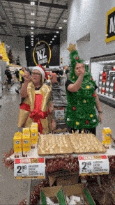 two people dressed up as christmas trees in a supermarket