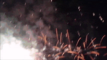fireworks are displayed in the night sky with smoke coming out of it