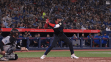 a baseball player is swinging at a pitch with a banner that says proud owner and fan