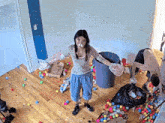 a woman with a bandage on her nose is standing in a room full of balls