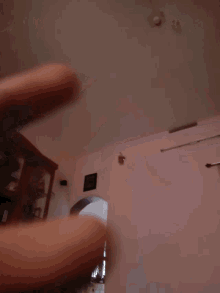 a person 's feet are visible in a blurry photo of a room