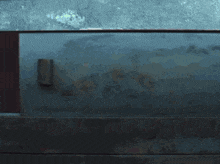 a person is looking through a hole in a wall
