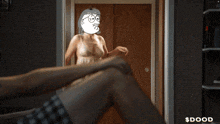 a man is laying on a bed with a mask on his face that says ' $ dood '