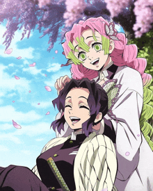 a girl with pink hair and green eyes is sitting next to another girl with purple hair