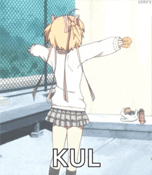 a girl in a school uniform is holding a cookie and the word kul is on the bottom