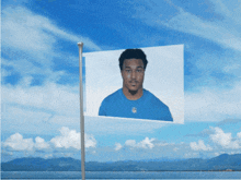 a picture of a man in a blue shirt is on a flag