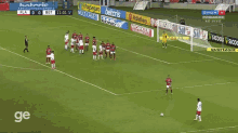 a soccer game is being played on a field with advertisements for betcris and worker