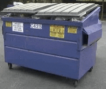 a blue dumpster with a plastic lid is sitting on the side of the road .