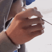 a close up of a person 's hand holding a spoon