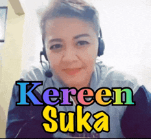a woman wearing headphones and a sticker that says ' keren suka ' on it