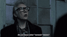 a man wearing glasses says do you know what " nemesis " means ..