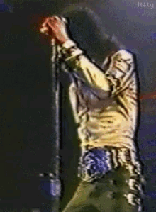 a painting of a man singing into a microphone with the letters n4ty on the bottom right