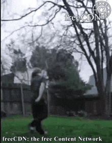 a man is jumping in the air in a park with a tree in the background .