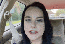 a woman in a car with a nose ring