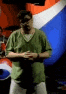 a blurry picture of a man in a green shirt