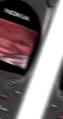 a close up of a nokia phone with a red screen