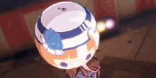 a girl with a hat on her head is holding a ball in her hand .