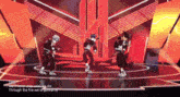 a group of people are dancing on a stage with the words we 'll never stop until we die through the fire