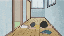a boy is laying on the floor with a book on the floor