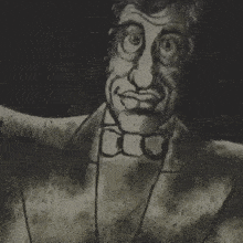 a close up of a man wearing a tuxedo and bow tie .