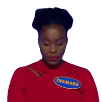 a woman wearing a red shirt with a patch that says thamara on it