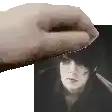 a hand is holding a black and white photo of a man