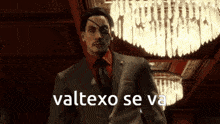 a man in a suit and red shirt stands in front of a chandelier with the words valtexo se va written on the bottom