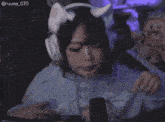 a girl wearing headphones and a cat ear headband has the number 070 on the bottom right