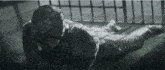 a man in a gas mask is laying on a tiled floor